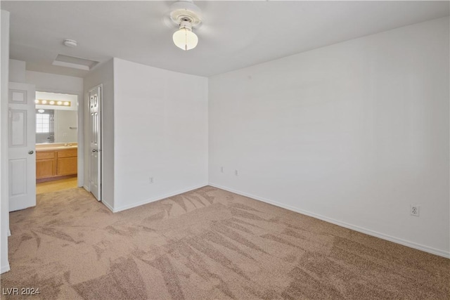 empty room featuring light colored carpet and sink