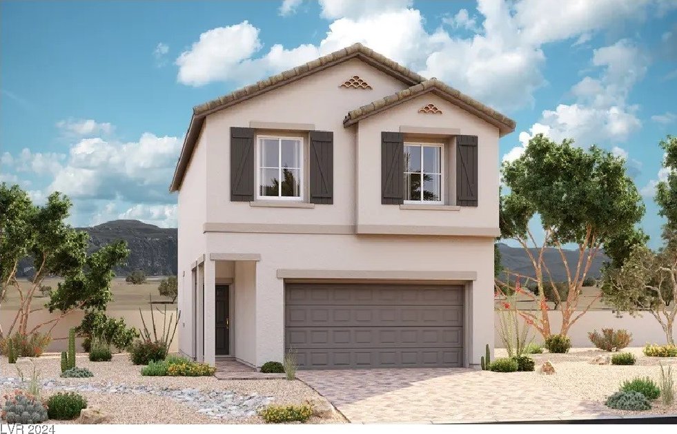 view of front of home with a mountain view and a garage