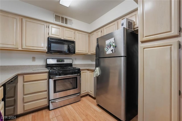 kitchen featuring light hardwood / wood-style flooring and black appliances