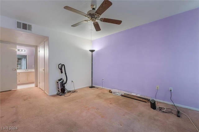 spare room featuring ceiling fan and light colored carpet