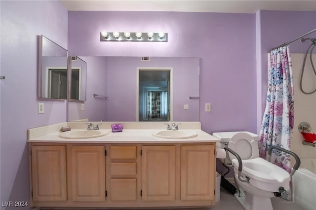 full bathroom with vanity, shower / bath combo, and toilet