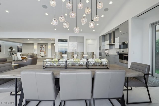 tiled dining space featuring lofted ceiling