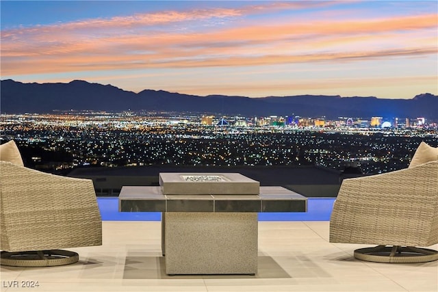 patio terrace at dusk featuring a mountain view