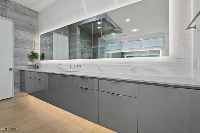 bathroom featuring vanity and a shower with shower door