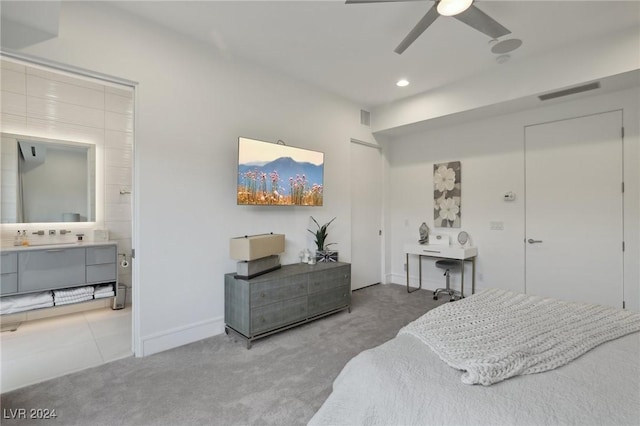 carpeted bedroom with ceiling fan and ensuite bathroom