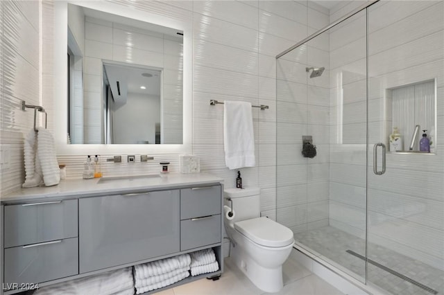 bathroom featuring a shower with door, tile walls, backsplash, toilet, and vanity