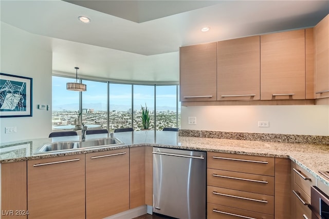 kitchen featuring light stone countertops, dishwasher, light brown cabinets, sink, and hanging light fixtures