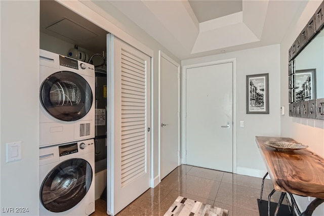 washroom featuring stacked washer / dryer