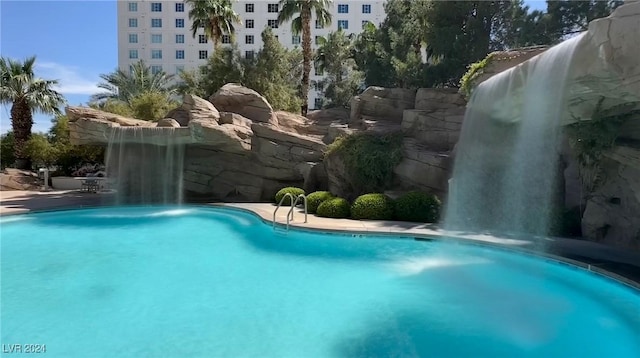 view of pool with pool water feature