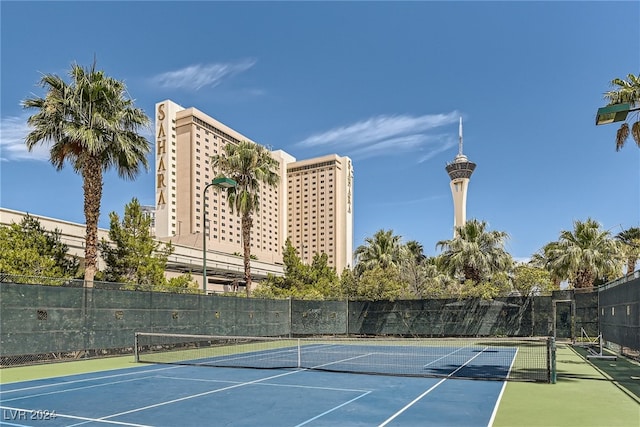 view of tennis court featuring basketball hoop