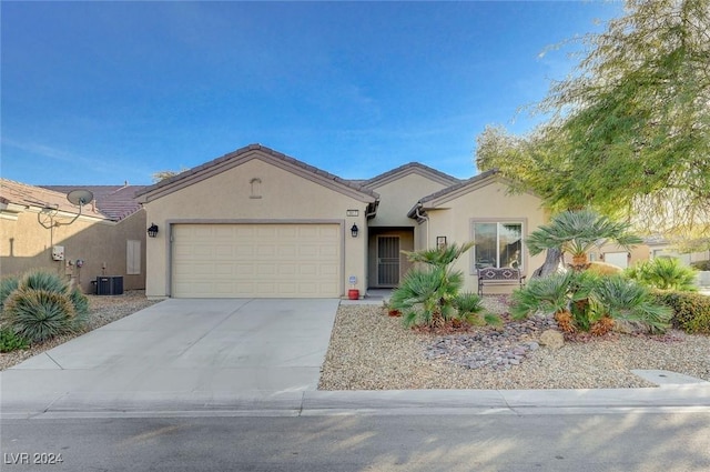 ranch-style house featuring cooling unit and a garage