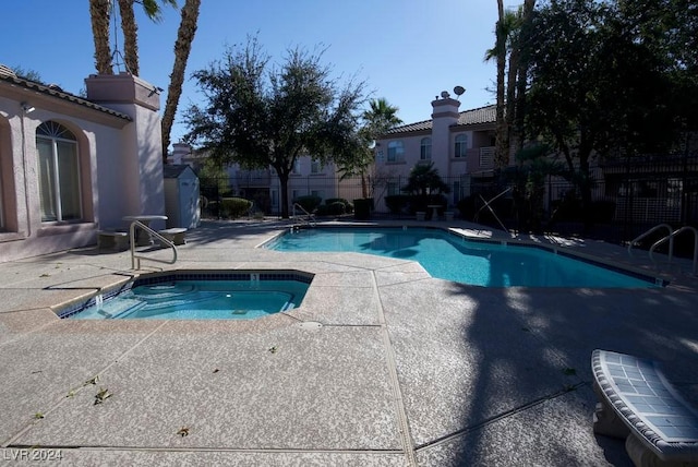 view of pool featuring a patio area and a community hot tub