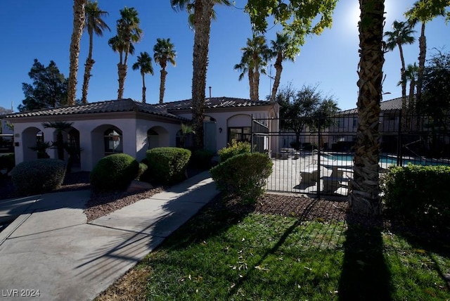 mediterranean / spanish-style house with a fenced in pool