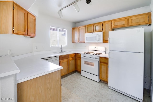 4555 E Sahara Ave Unit 223, Las Vegas, NV 89104 - kitchen featuring white appliances, light floors, light countertops, a peninsula, and rail lighting