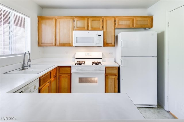 kitchen featuring white appliances and sink