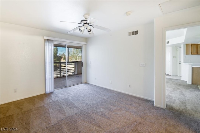 carpeted spare room with ceiling fan