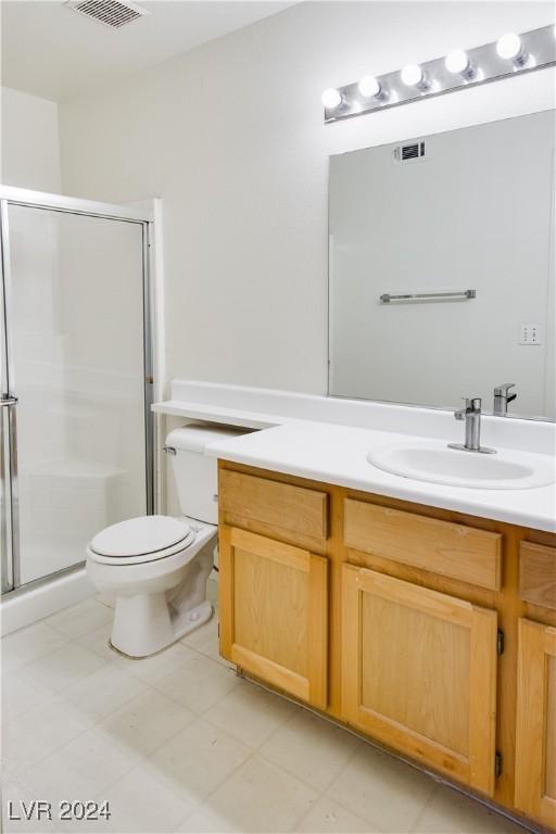 bathroom with vanity, toilet, and an enclosed shower