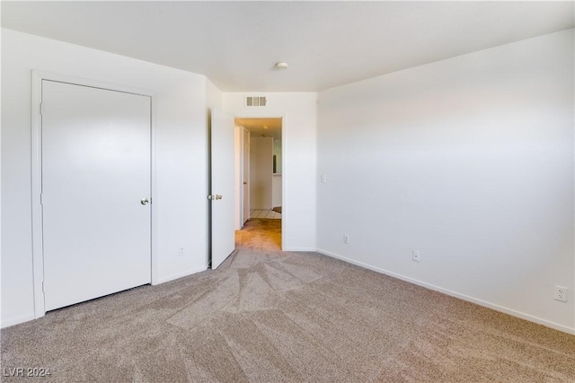 unfurnished bedroom with light carpet