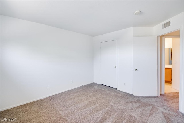 unfurnished bedroom with light colored carpet