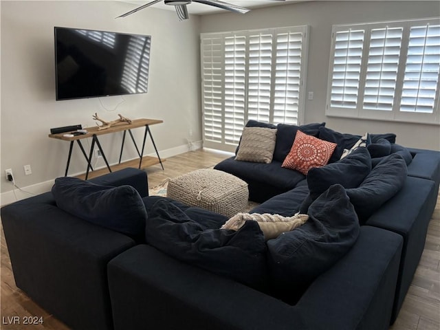 living room featuring ceiling fan and wood-type flooring