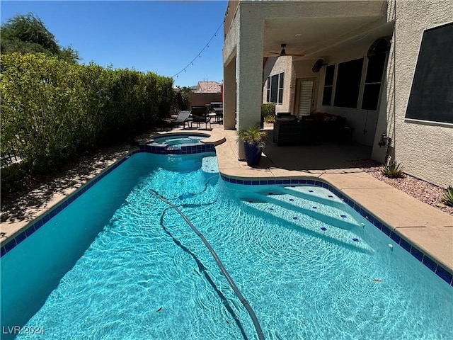 view of swimming pool with an in ground hot tub, ceiling fan, and a patio