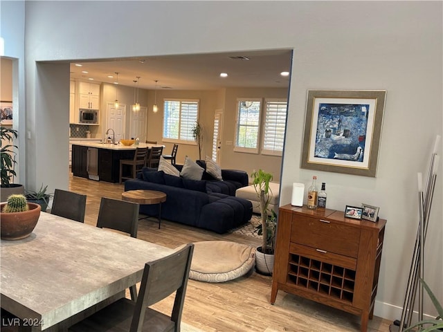 dining space featuring light hardwood / wood-style flooring and sink