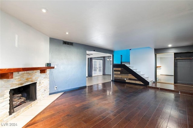 unfurnished living room with a fireplace and hardwood / wood-style flooring