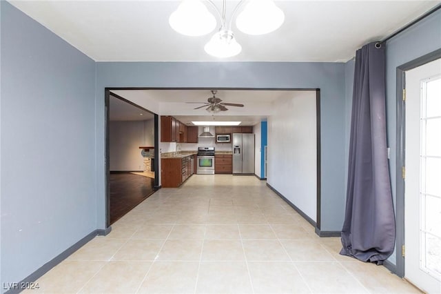 corridor featuring light tile patterned floors and a chandelier