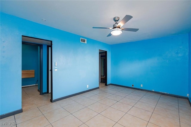 unfurnished room featuring ceiling fan and light tile patterned floors