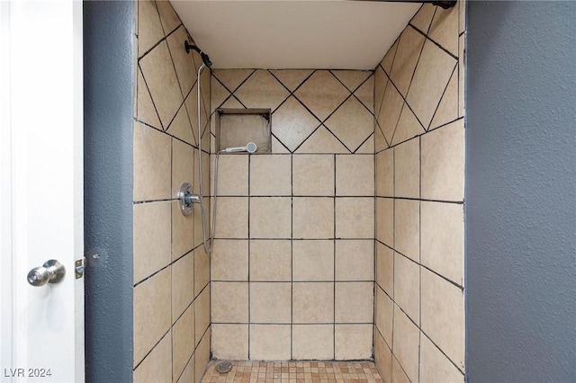 bathroom with a tile shower