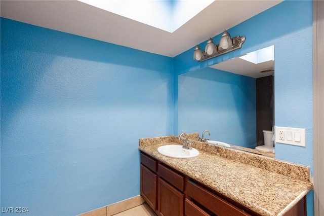 bathroom featuring tile patterned floors, vanity, and toilet