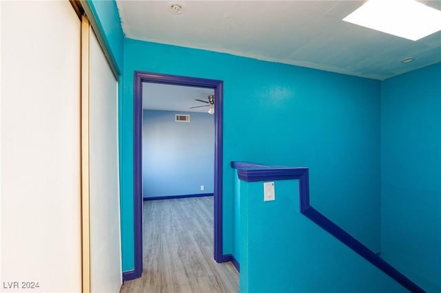 hallway with light hardwood / wood-style flooring