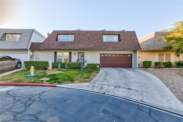 view of front of property with a front yard and a garage