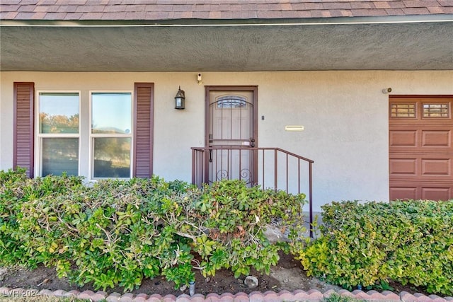 entrance to property featuring a garage