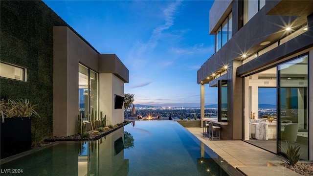 view of pool at dusk