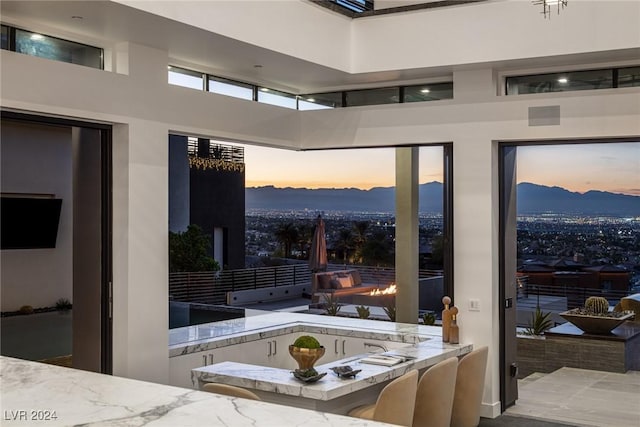 entryway featuring a mountain view and a towering ceiling