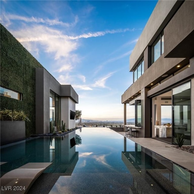 view of pool at dusk