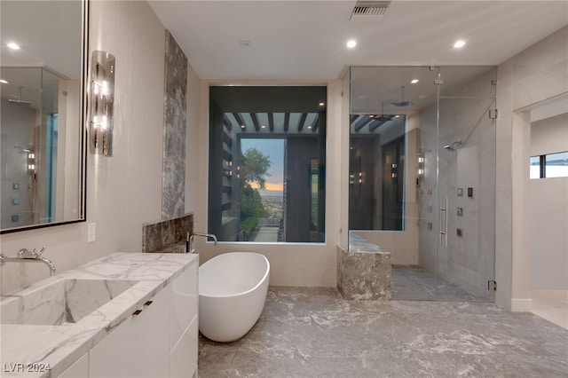 bathroom featuring vanity and separate shower and tub