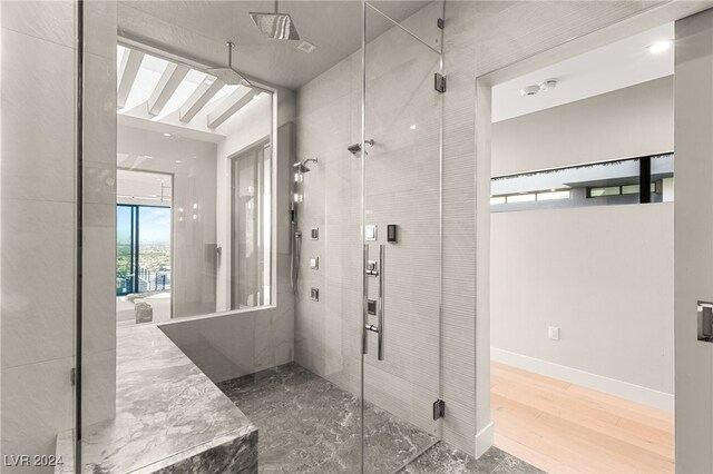 bathroom featuring hardwood / wood-style floors and a shower with shower door