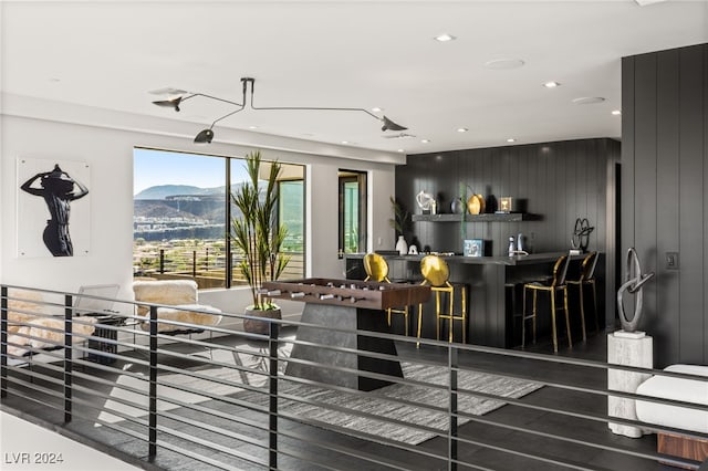 interior space featuring a mountain view, wooden walls, and wood-type flooring