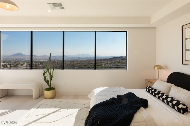 bedroom featuring a mountain view and hardwood / wood-style floors