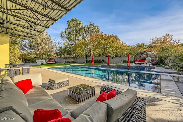 view of pool featuring outdoor lounge area, a patio, and pool water feature