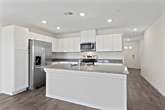 kitchen with dark wood-type flooring, a center island with sink, white cabinets, sink, and stainless steel appliances