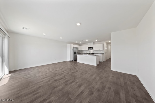 unfurnished living room with dark hardwood / wood-style flooring