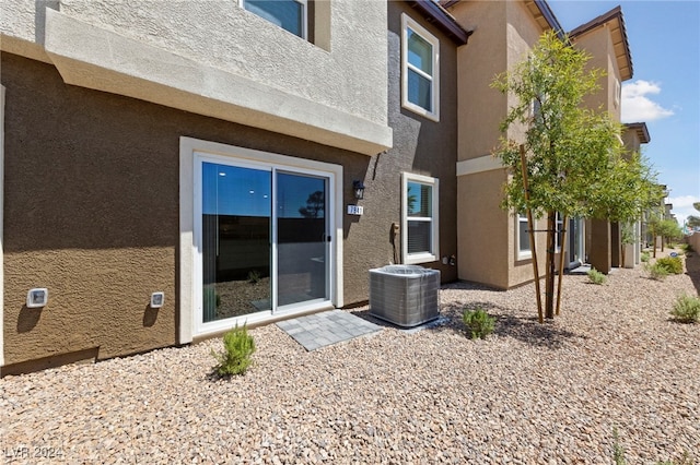 rear view of house with cooling unit