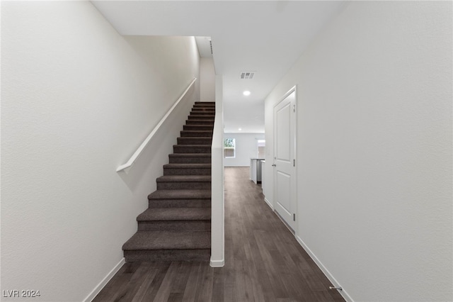 stairs featuring hardwood / wood-style flooring