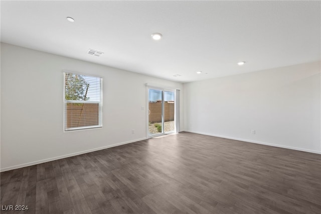 unfurnished room featuring dark wood-type flooring