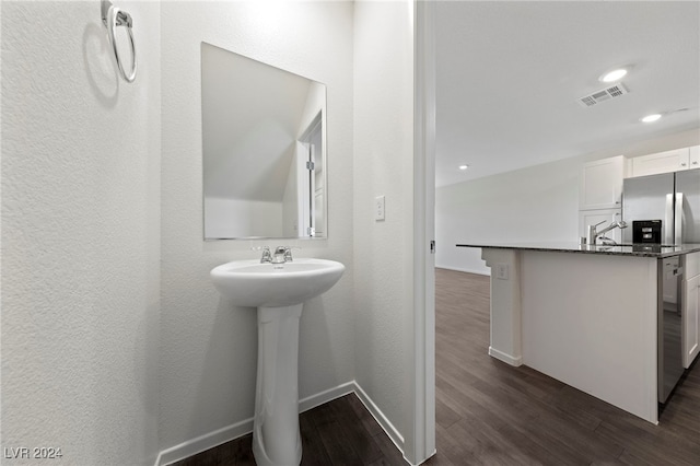 bathroom with sink, beverage cooler, and hardwood / wood-style flooring