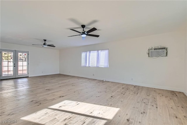 spare room featuring plenty of natural light, french doors, and light wood-type flooring