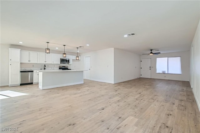 unfurnished living room with ceiling fan, light hardwood / wood-style flooring, and sink